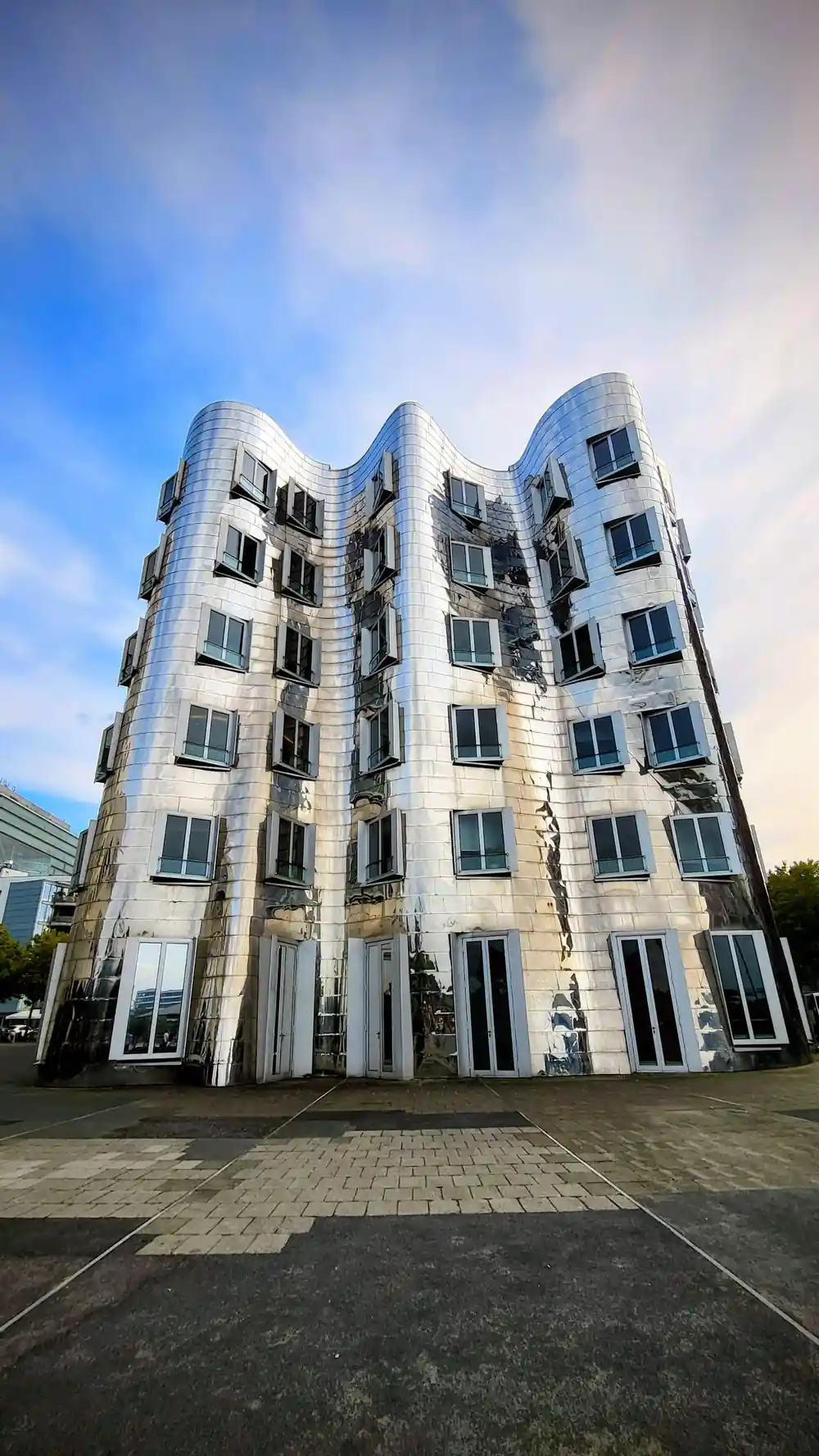 Curved white building with multiple rounded floors