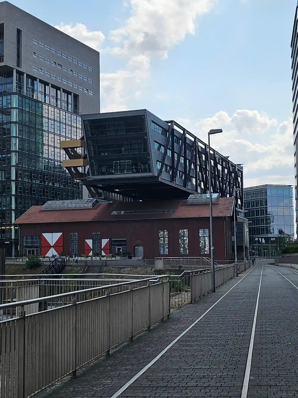 Modern building appearing to topple over red base
