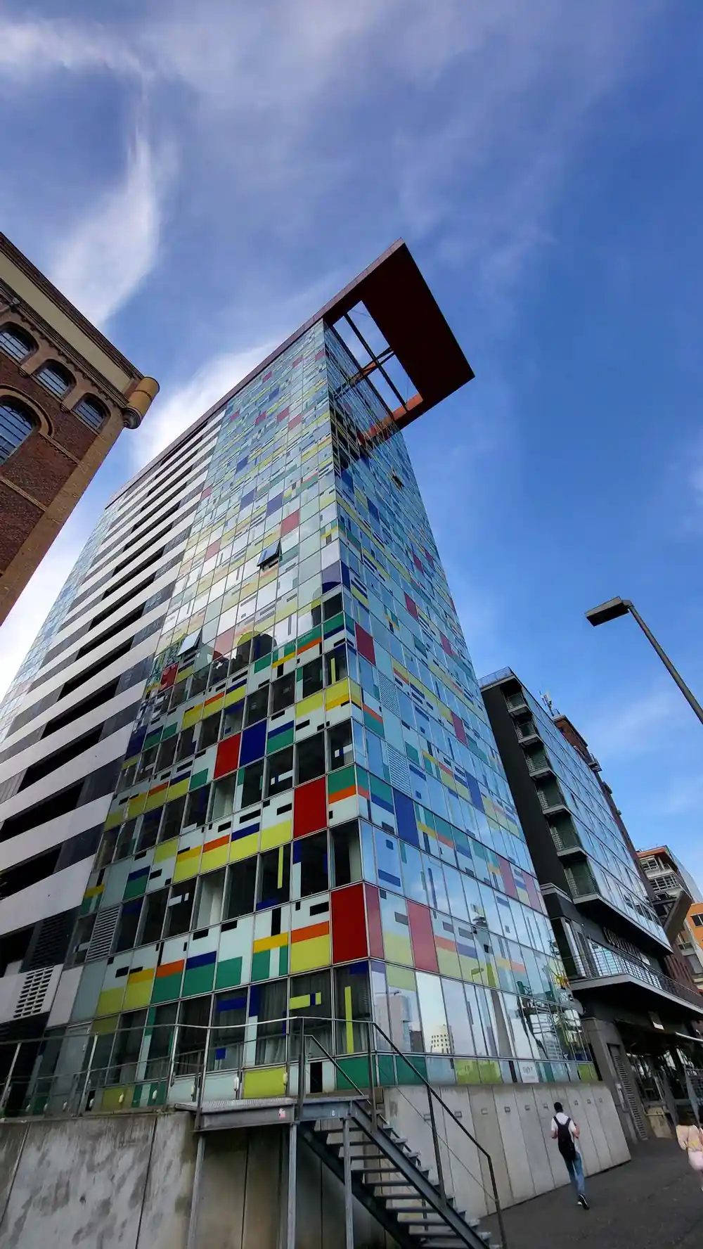 Tall residential tower with colorful window panels