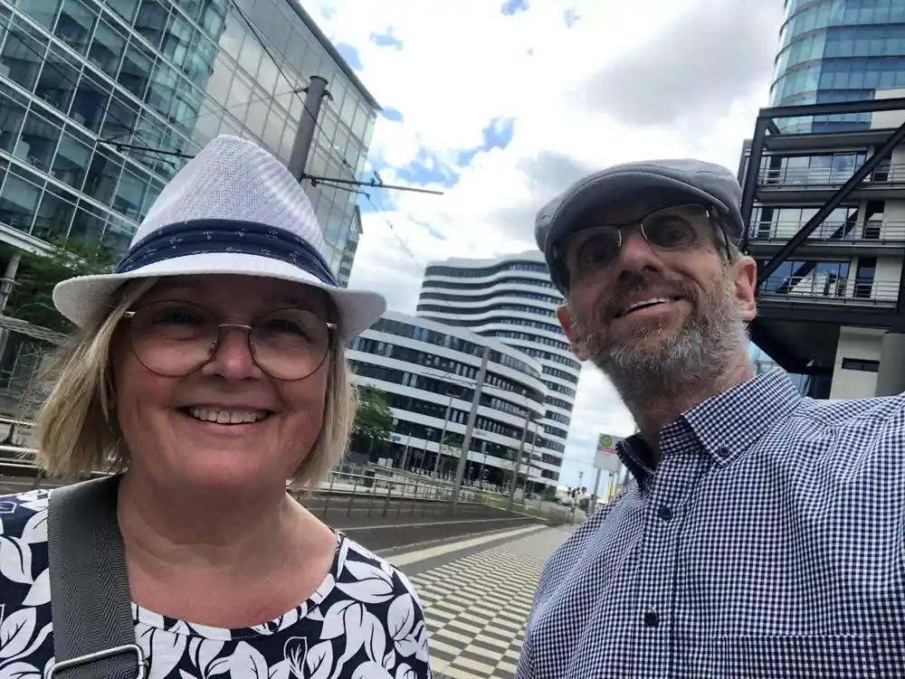 Two people smiling at camera wearing hats